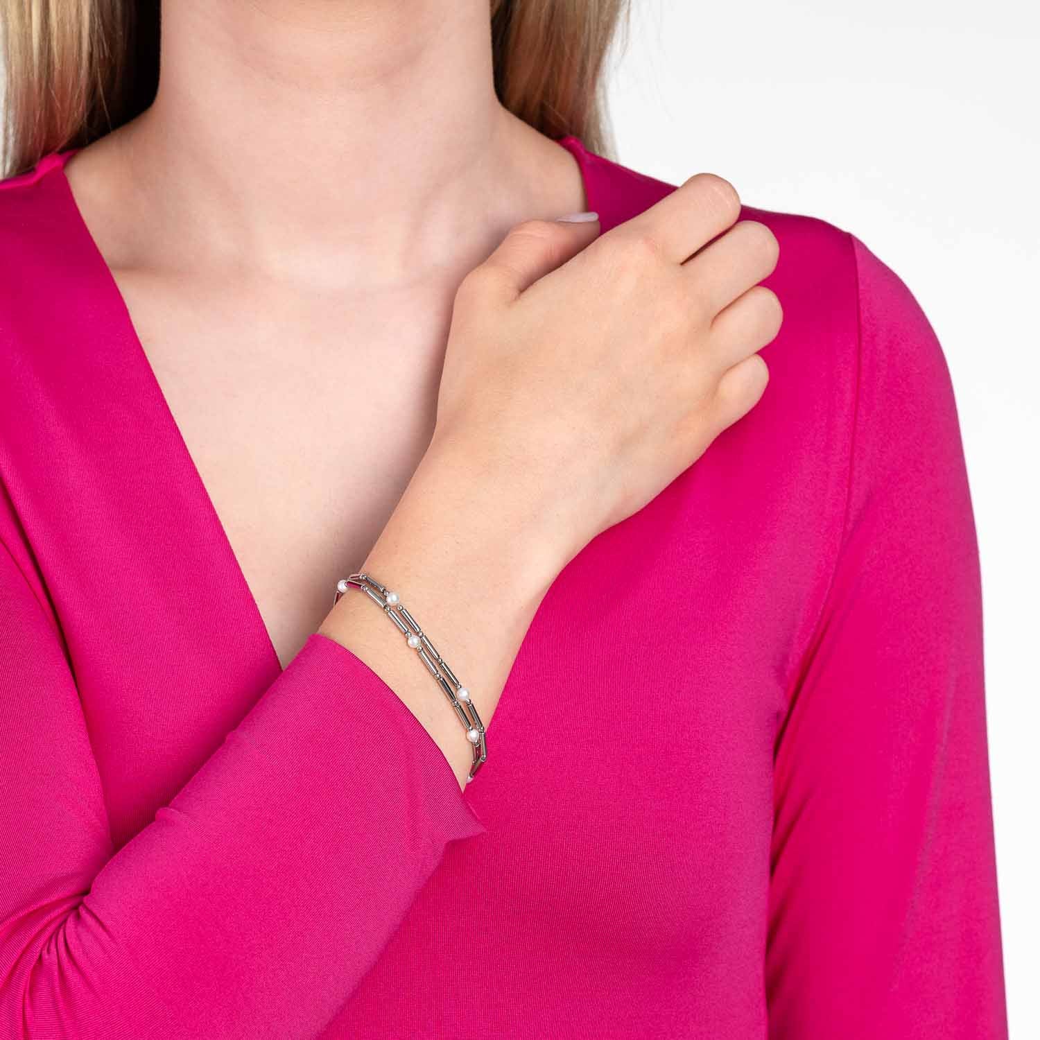 Frau trägt silbernes Armband MIRELLA am Handgelenk, rosa Oberteil