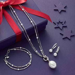 Armband MIRELLA mit Halskette, Ohrhänger und Geschenkbox auf violettem Hintergrund