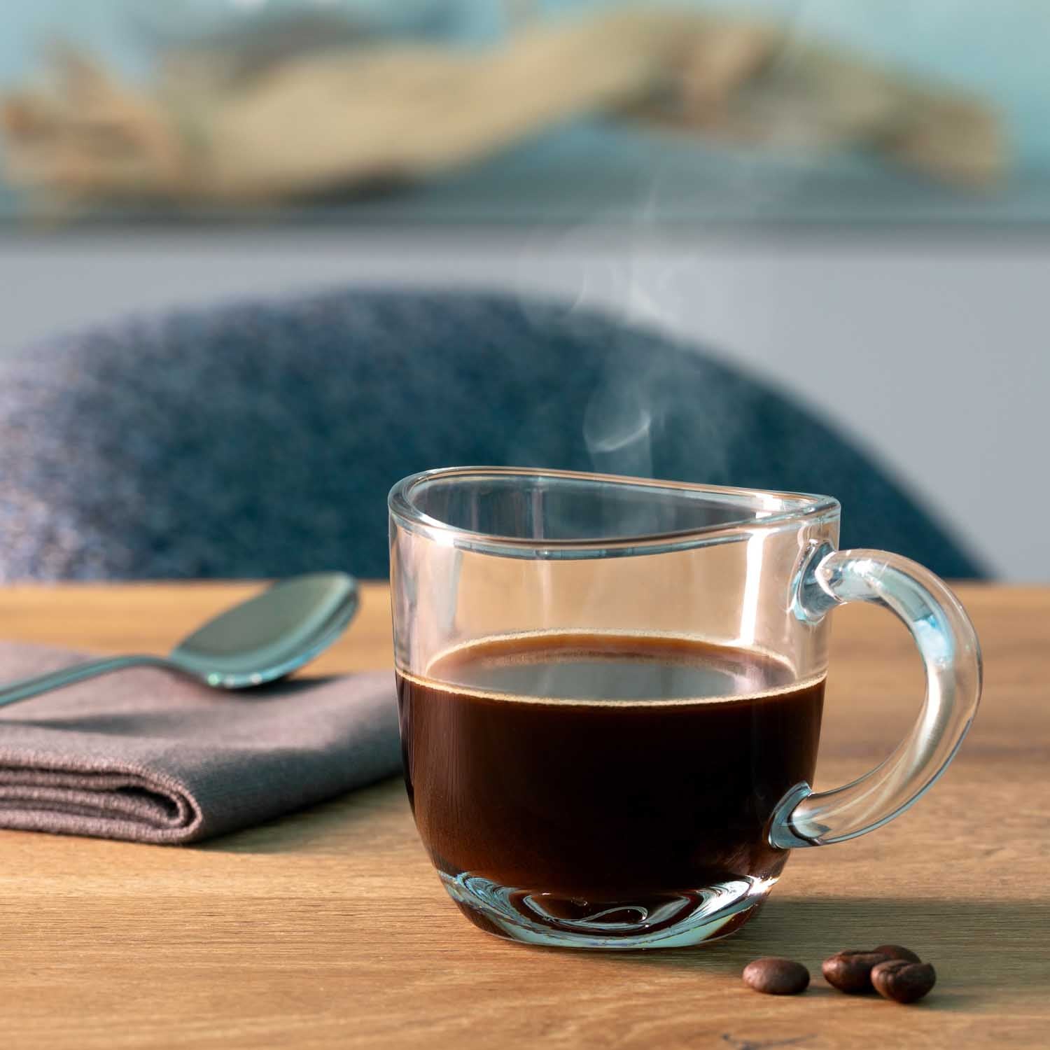 Espressotasse NAPOLI mit schwarzem Kaffee auf Holztisch, Kaffeebohnen daneben