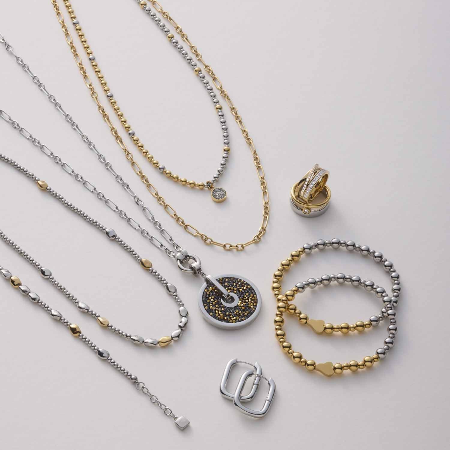Halskette NINON mit Clip & Mix Schmuckelementen in Silber und Gold auf grauem Untergrund