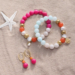Creole SOLERA gold pink und Armband auf Sand mit Seestern