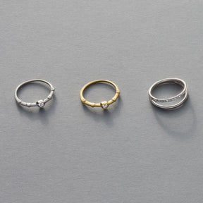 Drei Ringe TINI 19 CIAO in Silber und Gold auf grauem Hintergrund