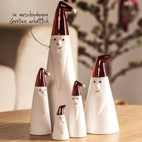 Weihnachtsmänner GIANNI in verschiedenen Größen mit roten Mützen auf Holztisch