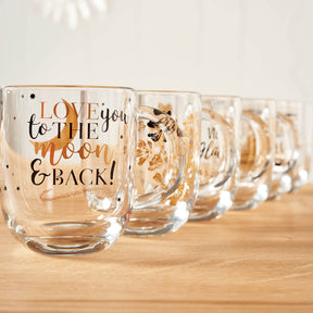 Tasse EMOZIONE mit Gravur "Love you to the moon and back" auf Holztisch, mehrere Tassen nebeneinander